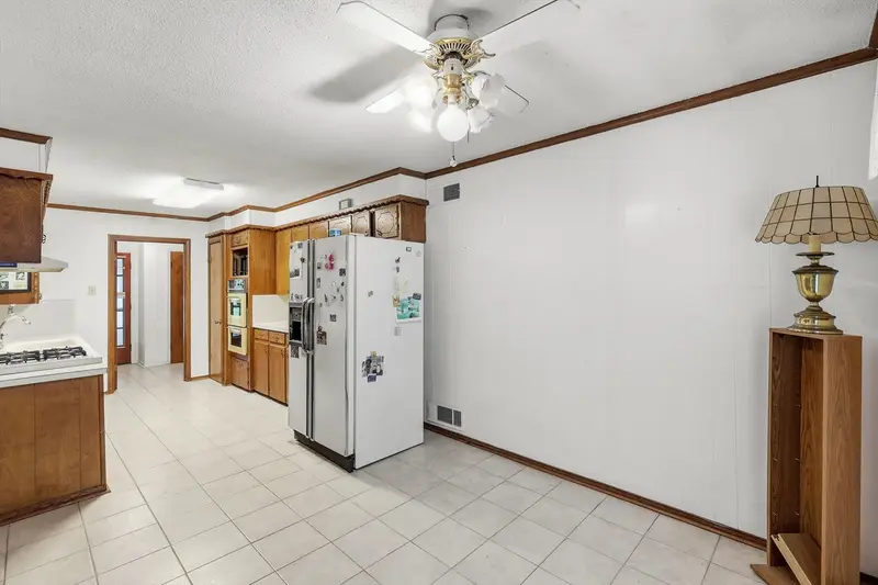 Eat-in kitchen area with tile floor, wood cabinets and a gas cooktop
