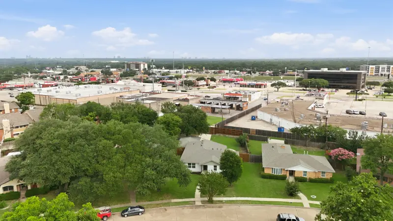 Aerial of the property and neighborhood with the downtown Dallas skyline in the distance